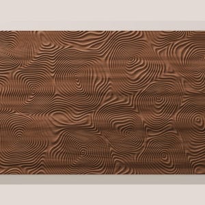 May include: A rectangular brown wooden panel featuring a carved, three-dimensional surface pattern of concentric, swirling circular lines that resemble the organic growth rings found in the cross-section of a tree trunk.