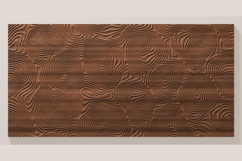 May include: A rectangular brown wooden panel featuring a carved, three-dimensional surface pattern of concentric, swirling circular lines that resemble the organic growth rings found in the cross-section of a tree trunk.
