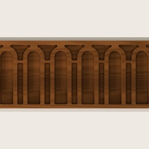 May include: A horizontal wooden molding strip featuring a repeating pattern of arched cutouts. The dark brown wood grain is visible throughout the piece, which displays a series of vertical rectangular sections topped by rounded arches.