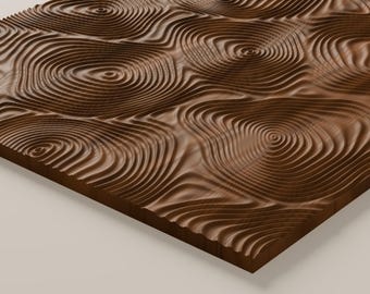 May include: A rectangular wooden panel featuring a carved, three-dimensional surface pattern of concentric, undulating circular rings that resemble topographical lines or ripples in water, finished in a rich, dark brown wood grain.