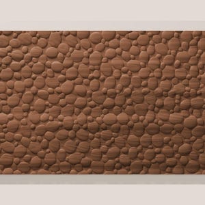 May include: A rectangular wooden wall panel featuring a three-dimensional surface texture composed of numerous rounded, pebble-like shapes of varying sizes. The wood displays a consistent medium-brown tone with visible horizontal grain patterns.