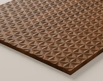 May include: A rectangular wooden panel featuring a repeating geometric pattern of carved, three-dimensional triangles. The surface displays a natural brown wood grain with alternating light and dark tones across the textured, faceted surface.