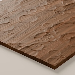 May include: A rectangular wooden panel featuring a natural brown wood grain texture. The surface is carved with numerous circular indentations of varying sizes, creating a relief pattern that resembles ripples on water or craters.