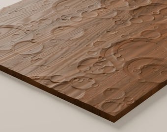 May include: A rectangular wooden panel featuring a natural brown wood grain texture. The surface is carved with numerous circular indentations of varying sizes, creating a relief pattern that resembles ripples on water or craters.