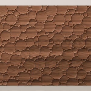May include: A rectangular wooden panel featuring a carved, three-dimensional surface pattern of interconnected circular and polygonal shapes of varying sizes, creating a textured, relief-like appearance with a natural brown wood grain finish.