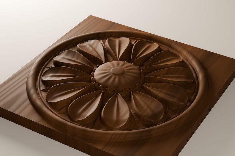 May include: A square wooden plaque featuring a circular medallion with a carved floral design. The center has a rounded, textured button shape surrounded by two layers of smooth, pointed petals, all set within a raised circular frame.