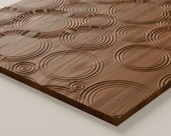 May include: A rectangular wooden panel featuring a carved surface texture of concentric circles that mimic the appearance of ripples in water. The wood grain is visible throughout the brown surface, with varying sizes of circular indentations.