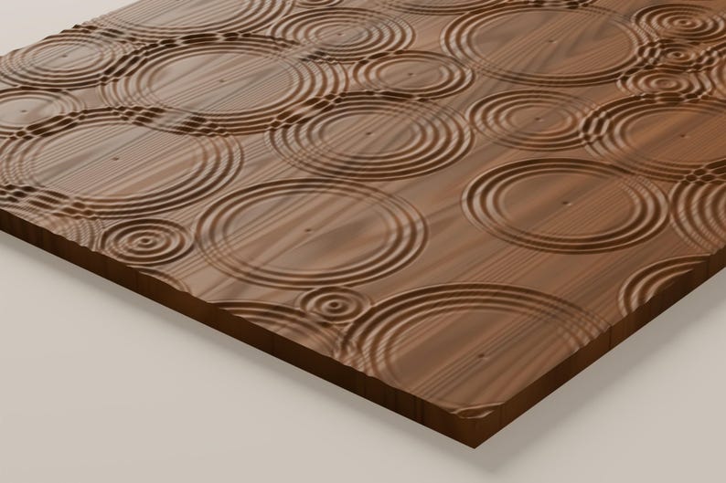 May include: A rectangular wooden panel featuring a carved surface texture of concentric circles that mimic the appearance of ripples in water. The wood grain is visible throughout the brown surface, with varying sizes of circular indentations.