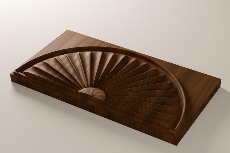 May include: A rectangular dark brown wooden block featuring a carved semi-circular fan pattern. The design consists of multiple radiating grooves that originate from a central point, creating a textured, dimensional surface on the wood.
