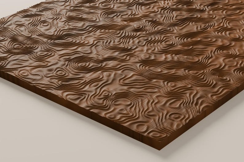 May include: A rectangular wooden panel featuring a carved, three-dimensional topographic map pattern. The surface displays intricate, flowing concentric lines and ridges that mimic natural terrain elevations in a rich, dark brown wood grain.