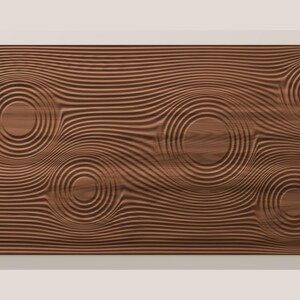 May include: A rectangular wooden wall panel featuring a dark brown finish and a carved surface texture. The design consists of horizontal lines that ripple outward into five distinct circular patterns, mimicking the effect of water drops.