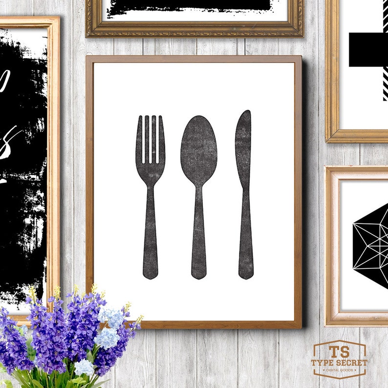 May include: A black and white print of a fork, spoon, and knife in a wooden frame. The print is on a white background.
