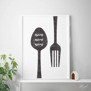 May include: Black and white print of a fork and spoon with the word "nom" repeated three times on the spoon.