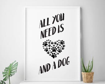 May include: Black and white printable wall art with the text "All you need is and a dog" with a heart made of paw prints.