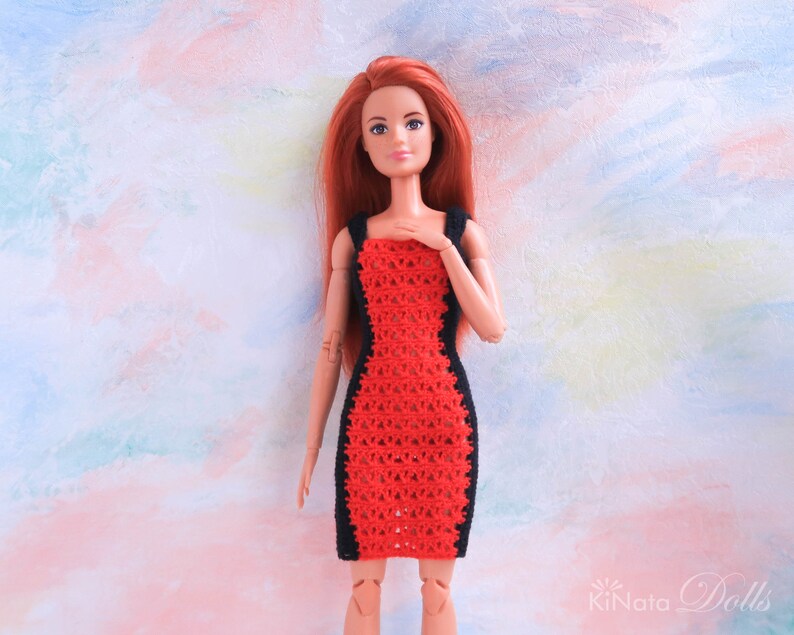 May include: A red and black crochet dress for a doll. The dress has a fitted silhouette and a scoop neckline.