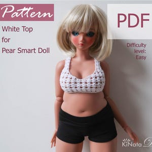 May include: A doll wearing a white crochet top and black shorts. The doll has blonde hair and blue eyes. The image includes the text "Pattern", "White Top for Pear Smart Doll", "PDF", and "Difficulty level: Easy".