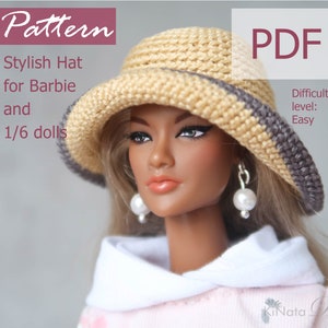 Peut inclure: Un patron de crochet pour un chapeau élégant pour Barbie et les poupées 1/6. Le patron est disponible en téléchargement PDF et est facile à suivre. Le chapeau est beige avec une bordure marron.