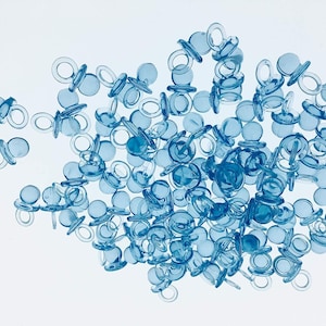 May include: A large quantity of blue plastic baby bottle pacifier shaped party favors.