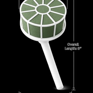 May include: A round green floral foam cage with a white plastic frame and handle. The plastic width is 3.75 inches, the overall length is 8 inches, and the overall width is 4.15 inches. The structure features a circular top and a straight handle.