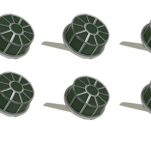 May include: A set of six circular floral foam cages with dark green foam inserts encased in a silver-colored plastic grid frame. Each unit features a small, flat, protruding handle extending from the side of the circular base for mounting.