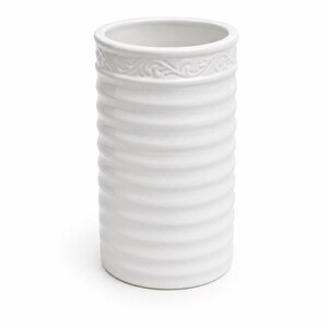 May include: White ceramic utensil holder with a ribbed design and a decorative floral pattern around the top. The cylindrical holder is approximately 6 inches tall and 4 inches in diameter. The background is white.