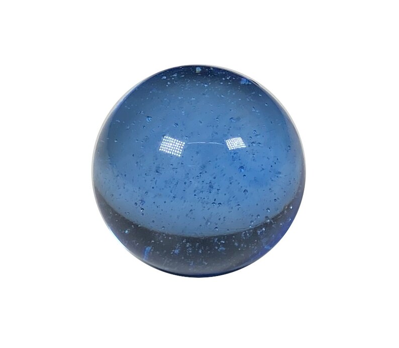 May include: A blue glass marble with a speckled, cloudy appearance.
