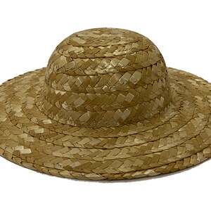 May include: A straw hat with a wide brim and a rounded crown. The hat is woven from natural straw and has a light brown colour.
