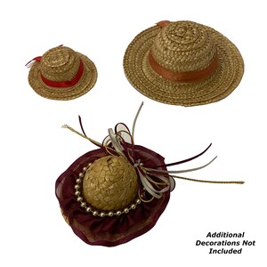 May include: Three straw hats with different trims. The largest hat has a wide brim and a brown ribbon. The medium hat has a red ribbon. The smallest hat has a burgundy ribbon and a beaded trim.