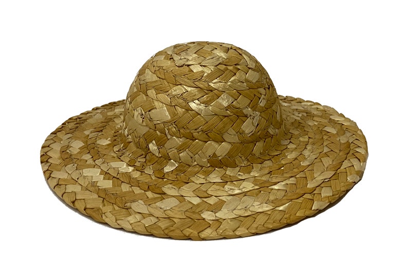 May include: A wide-brimmed straw hat with a woven design. The hat is light brown and has a rounded crown.