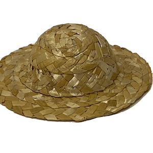 May include: A woven straw hat with a wide brim and a rounded crown. The hat is a light brown colour.