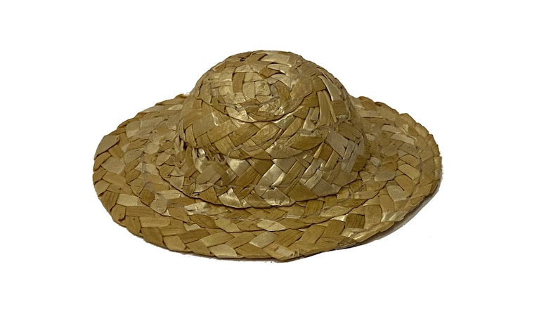 May include: A woven straw hat with a wide brim and a rounded crown. The hat is a light brown colour.
