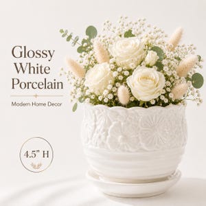 May include: A glossy white porcelain flower pot, 4.5 inches high, filled with white roses, baby's breath, and other greenery. The pot has a decorative floral pattern and sits on a matching saucer. Text on the image reads "Glossy White Porcelain" and "Modern Home Decor."