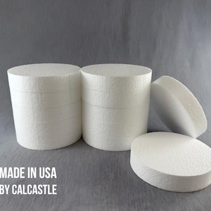 May include: Four white round foam cake dummies, two stacked and two laying flat. The foam cake dummies are made in the USA by Calccastle.