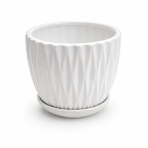 May include: A white ceramic plant pot with a glossy finish and a textured diamond-shaped pattern on the exterior. The pot features a scalloped top rim and sits on a matching circular white saucer base, providing a clean and simple look for plants.