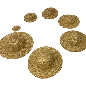 May include: A set of seven straw hats in various sizes, ranging from small to large. The hats are all made of natural straw and have a simple, classic design.