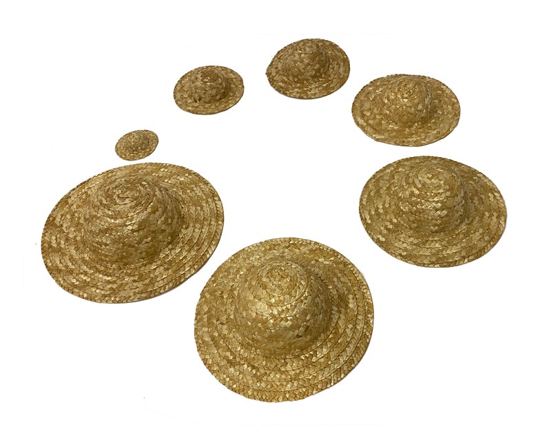 May include: A set of seven straw hats in various sizes, ranging from small to large. The hats are all made of natural straw and have a simple, classic design.