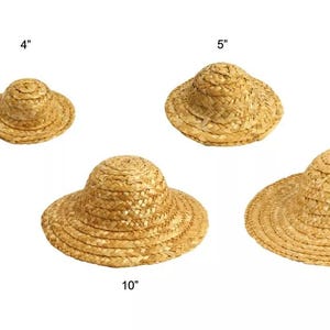 May include: Set of 10 straw hats in various sizes, ranging from 3 inches to 12 inches in diameter. The hats are all made of natural straw and have a classic, simple design.