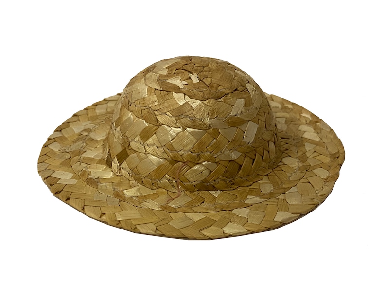 May include: A small, brown straw hat with a wide brim. The hat is woven from natural materials and has a simple, classic design.