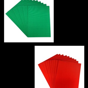 May include: A stack of 12 green and 12 red corrugated cardboard sheets. The sheets are ribbed and have a textured surface.