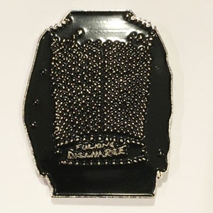 May include: Black enamel pin with a silver outline in the shape of a jacket. The pin has a textured surface and the words "Full-on Disarray" are printed in silver on the bottom.