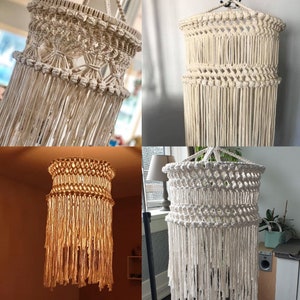 May include: Four macrame light fixtures in white, cream and beige. The light fixtures are made of knotted rope and have a fringe design.