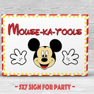 May include: A rectangular sign with the text "Mouse-ka-Tools" in red, featuring Mickey Mouse. The sign has a white background with a red and yellow border and the text "~ 5X7 SIGN FOR PARTY ~". The sign measures approximately 12.7cm x 17.8cm.