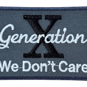 Puede incluir: Parche bordado gris con una "X" negra y el texto "Generation X We Don't Care" en blanco.