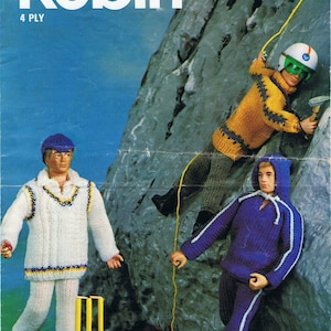 May include: Knitting pattern for three figures: a cricketer in white, a climber in yellow and brown, and a sporty figure in purple. The pattern is titled "Robin" and the number "2715" is printed on the cover. The pattern is for 4 ply yarn.