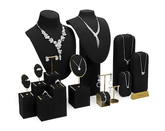 May include: A black jewelry display set with various stands and busts for necklaces, earrings, and rings. The set includes a sign that reads "JEWELRY".