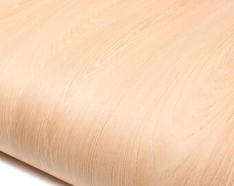 May include: Close-up of a light-colored wood grain pattern. The wood has a natural, warm tone with visible grain lines and subtle variations in color. The surface appears smooth and slightly curved.