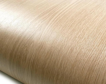 May include: A roll of light beige contact paper featuring a realistic wood grain pattern with vertical lines and subtle tonal variations. The surface has a smooth, semi-gloss finish that mimics the appearance of natural light oak wood texture.