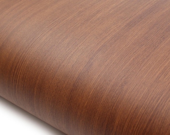 May include: Close-up of a roll of brown wood grain contact paper. The paper has a realistic wood texture with visible grain and a warm, natural color. The paper is rolled up, showing the edge and the texture.