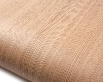 May include: Close-up of a roll of light brown wood grain contact paper. The paper has a textured surface with vertical lines and a slight curve, creating a natural wood appearance.