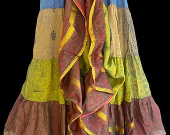 May include: A multi-colored patchwork skirt with a long, flowing design. The skirt is made of different fabrics and has a layered look. The skirt is a vibrant mix of blue, green, brown, and gold.
